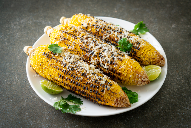 barbecue and grilled corn with cheese and lime