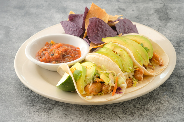 Specialty Fish Tacos with crackers served in a dish isolated on background side view of fastfood