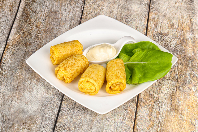 Stuffed pancakes with cream sauce